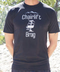 Person wearing a black t-shirt with 'Chairlift Brag' graphic and text.