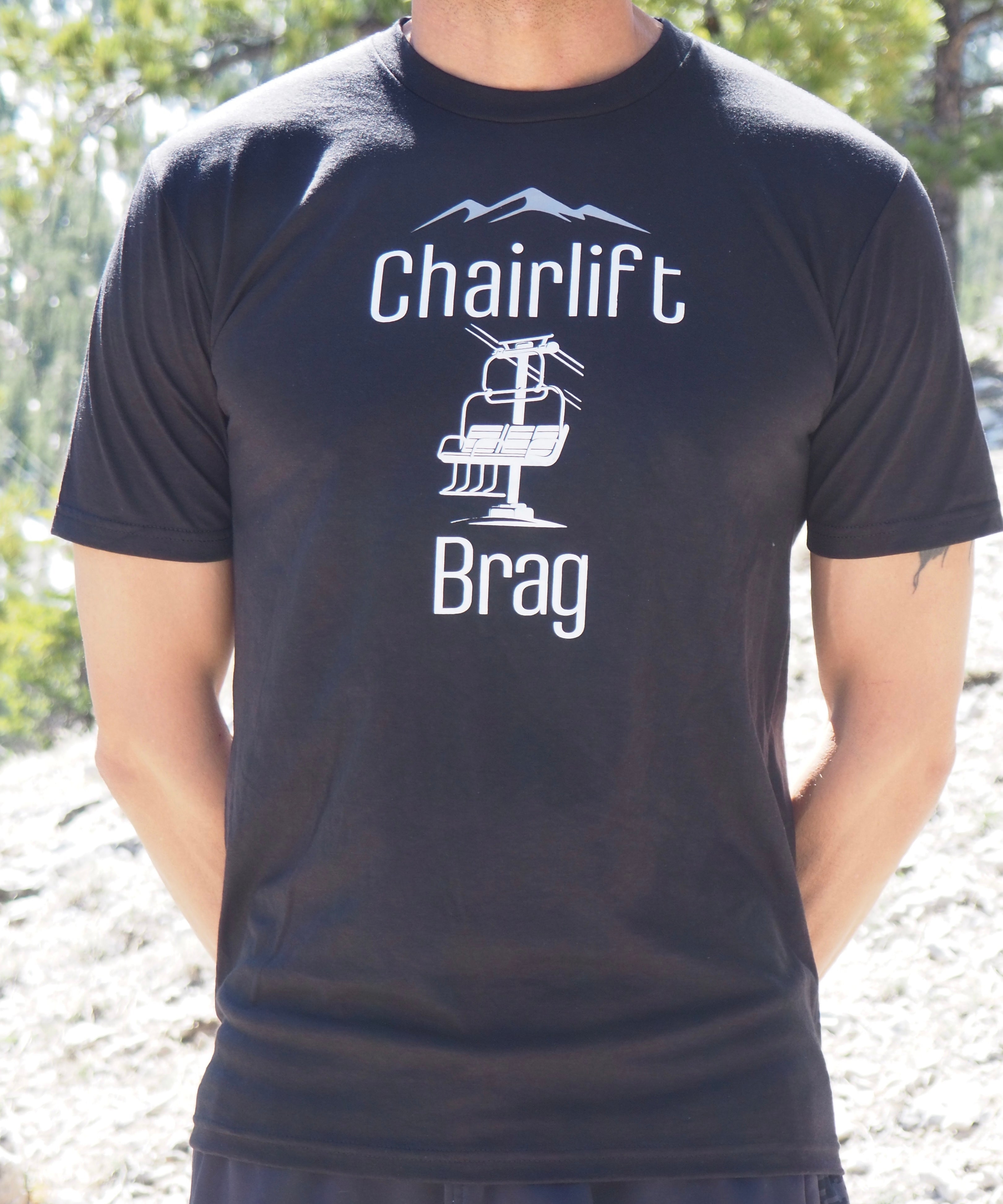 Person wearing a black t-shirt with 'Chairlift Brag' graphic and text.